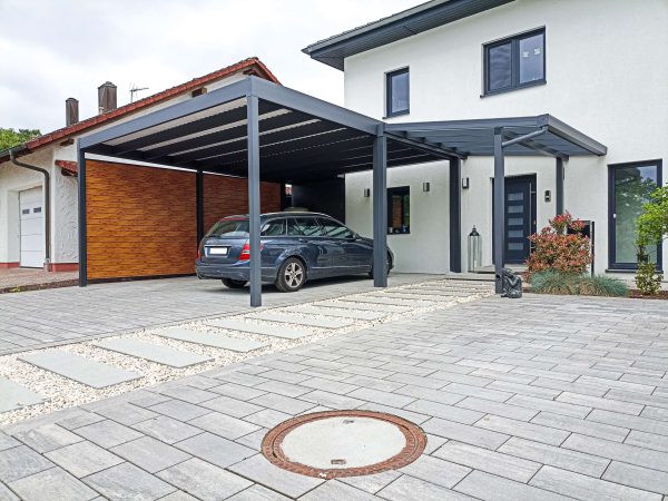 Freestanding carport with trapezoidal cover