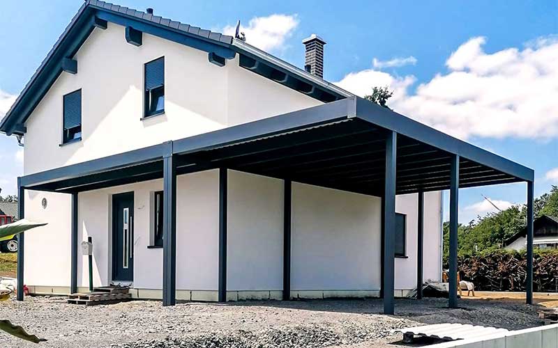 Wall mounted carport with protection of the entrance to the house
