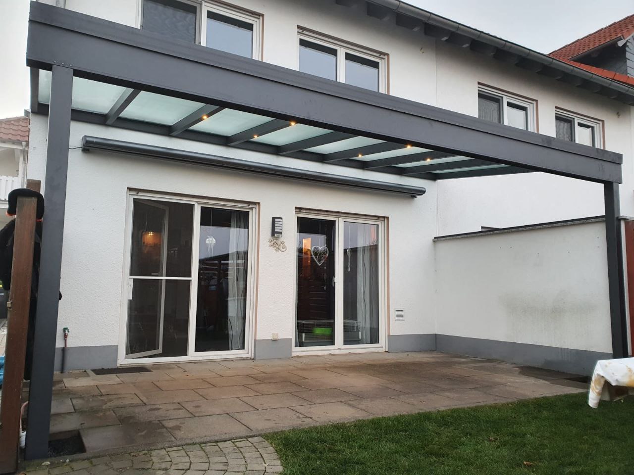 Pergola with polycarbonate roof and clear side panels