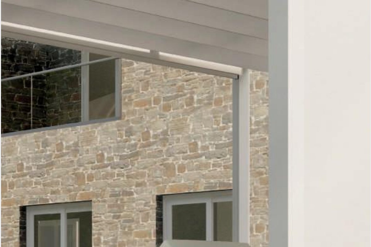 House with awning installed above patio seating area