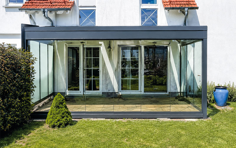 Garden room with all-glass side panels and a large sliding glass door