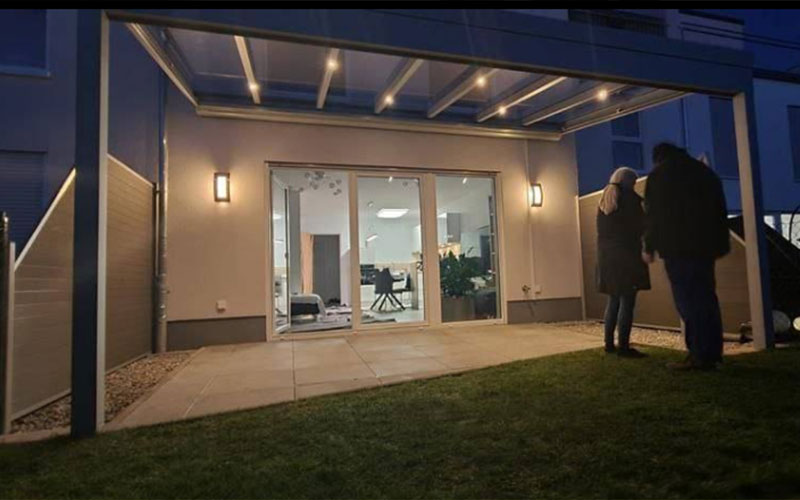Small pergola for a back garden with a polycarbonate roof and lighting