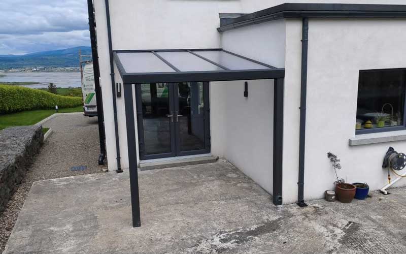 Wall-mounted aluminium structure beside a coastal home