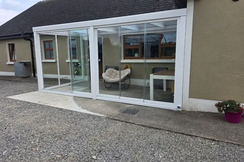 Fully enclosed aluminium garden room with sliding glass systems