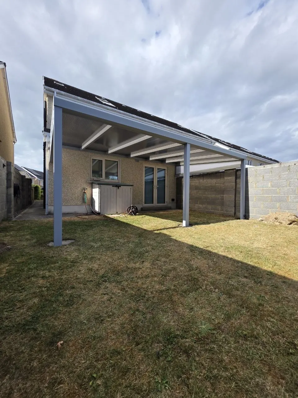 Completed silver-grey wall-mounted polycarbonate pergola in Monasterevin, Co. Kildare