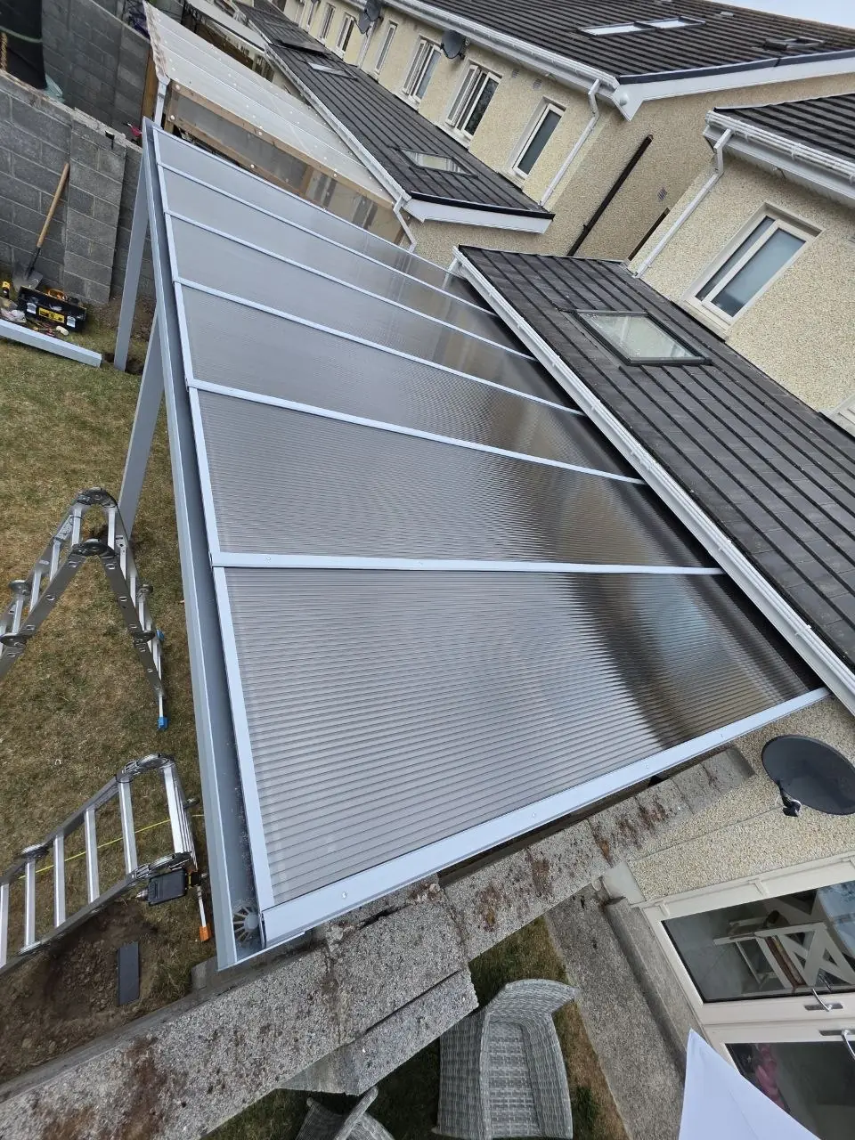 Fixed clear polycarbonate panels fitted to the pergola roof frame