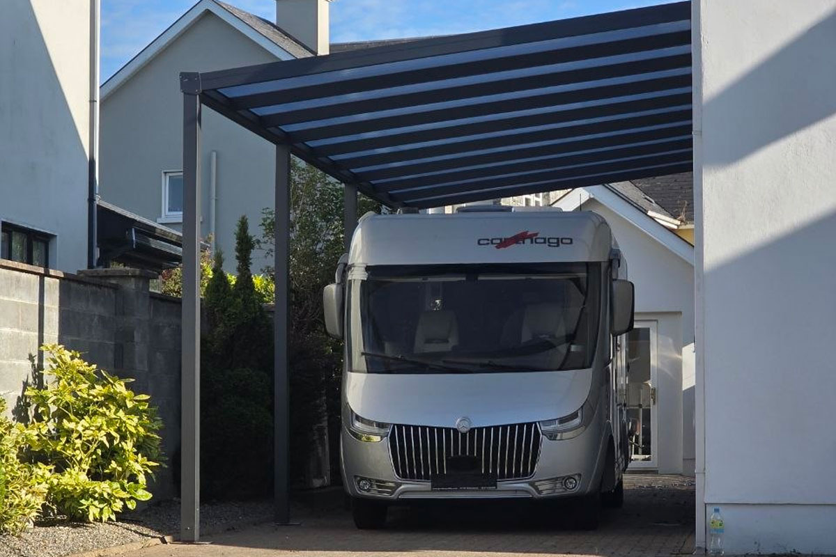 Wall-mounted aluminium motorhome carport with a polycarbonate roof completed by AVC Build
