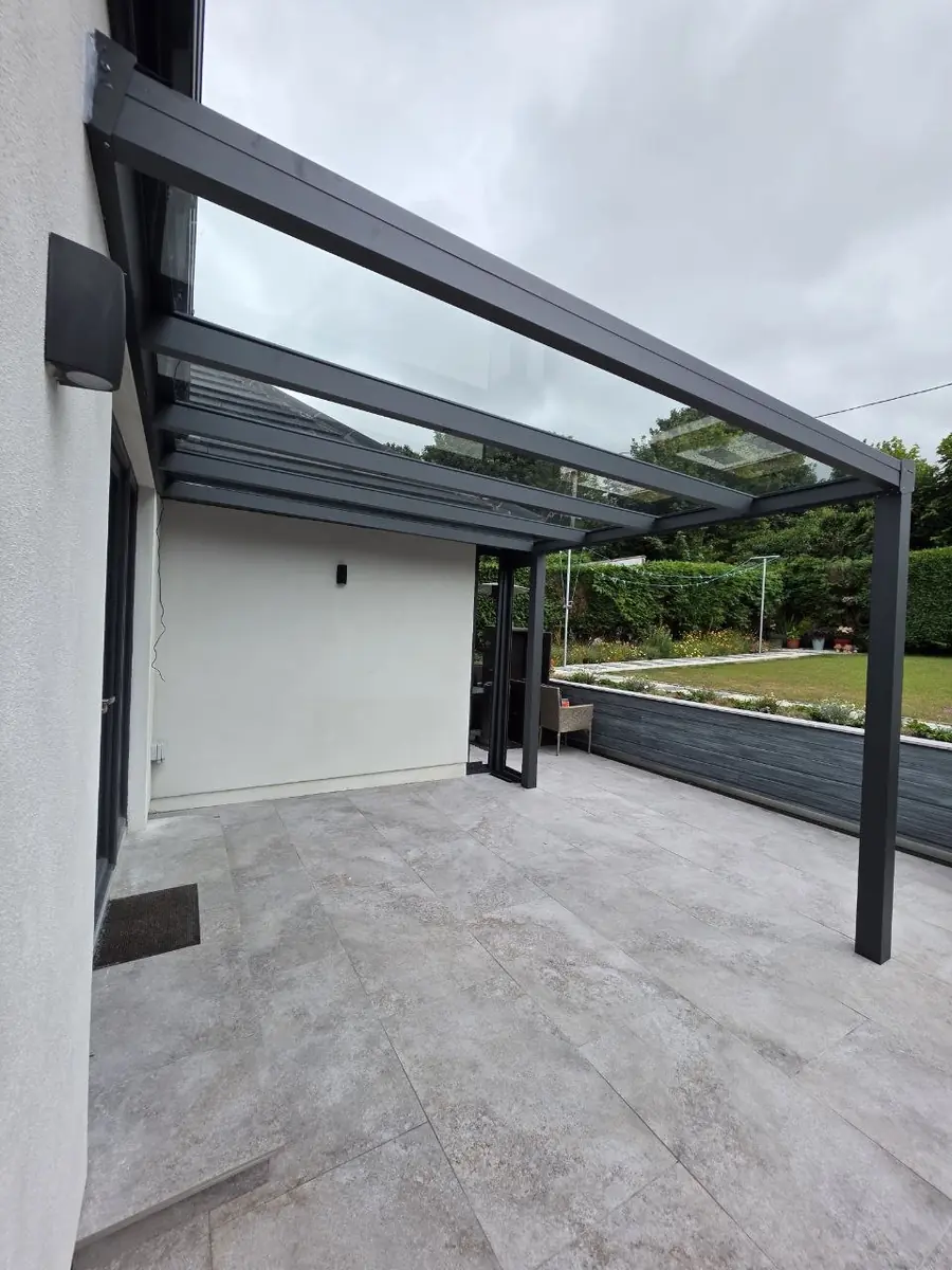 Clear glass-roof pergola covering a rear garden terrace in Middletown