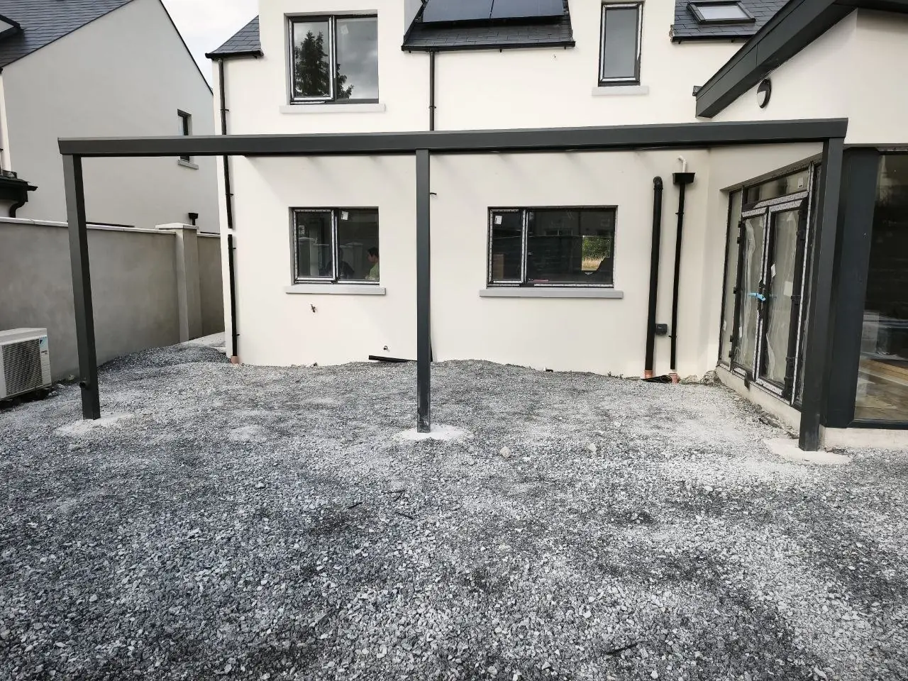 Two-post aluminium pergola frame installed on prepared concrete foundations