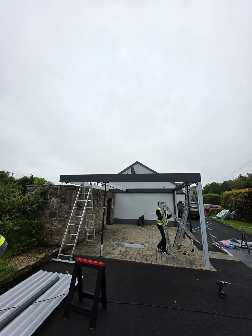 Freestanding aluminium carport frame during installation in Newport