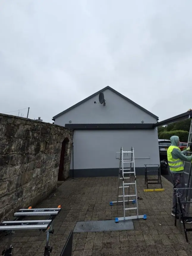 Early carport installation work beside the existing stone wall in Newport