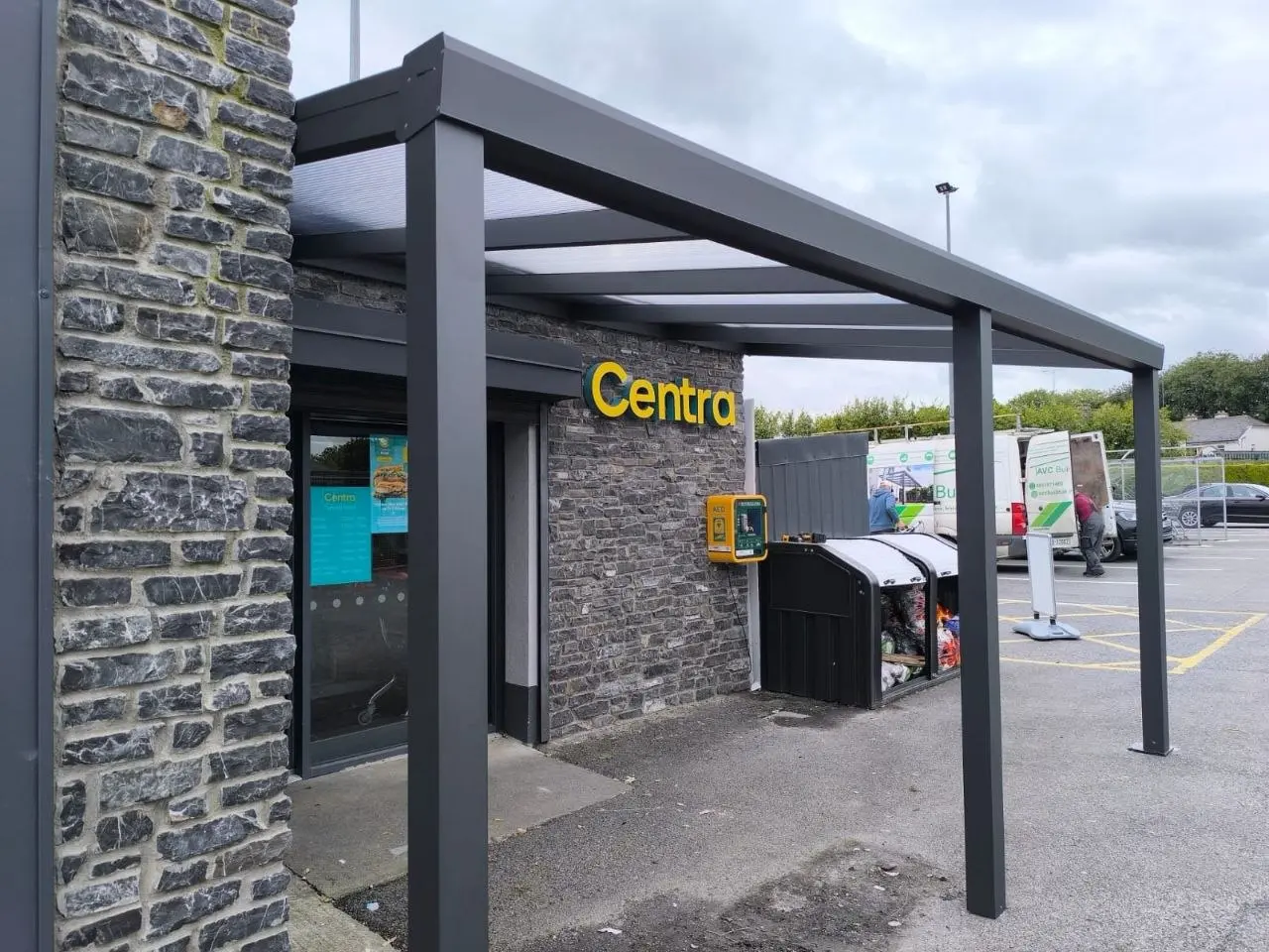 Side angle showing the black aluminium canopy structure outside the Roscommon store
