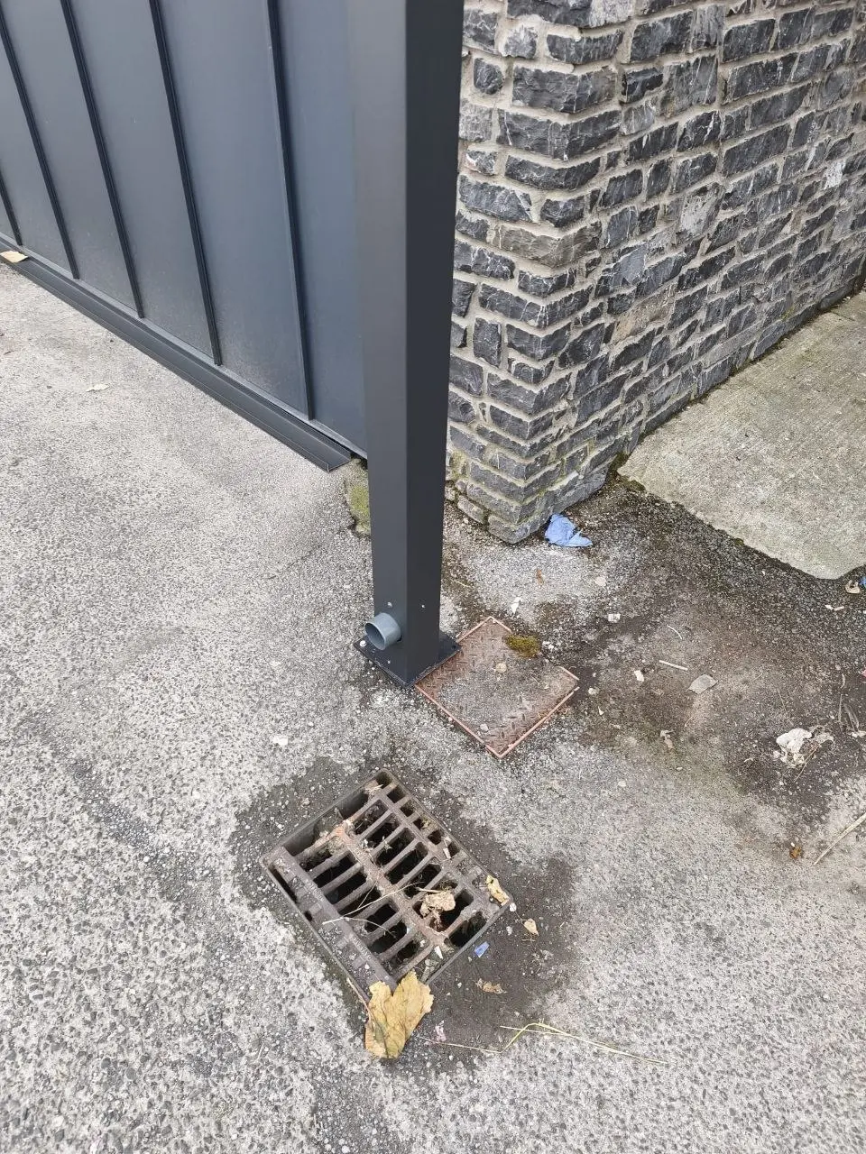 Canopy support post fixed to the existing paved base beside the Centra store