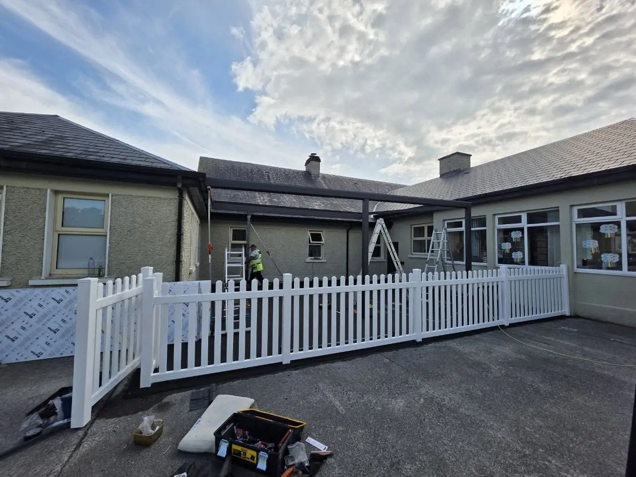 Wide view of the black aluminium school canopy frame during installation at Meelick Primary School