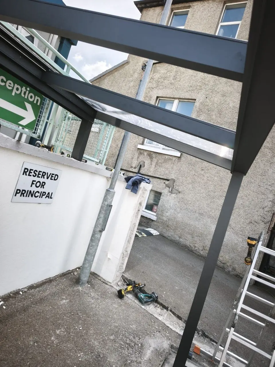Black aluminium school shelter frame during installation in Cashel