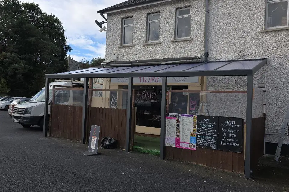 Wall-mounted aluminium canopy with a clear polycarbonate roof at a business in Naas, County Kildare