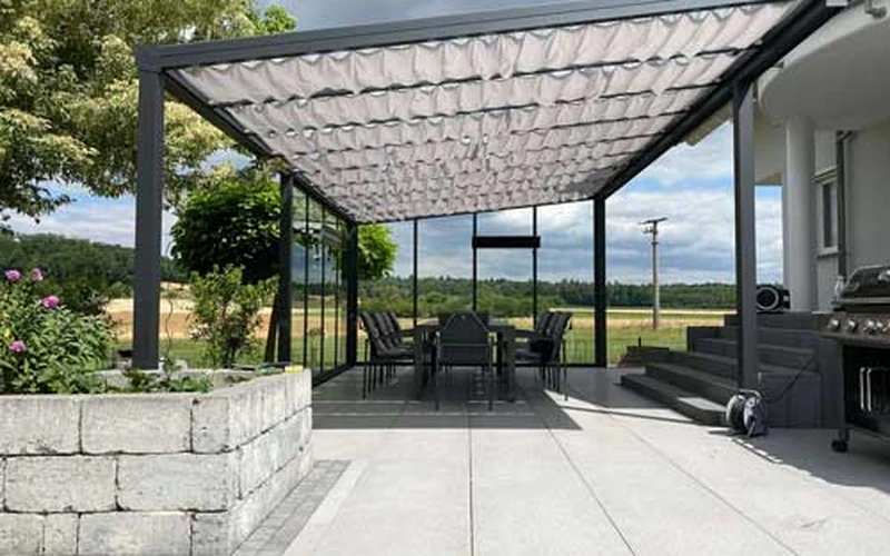 Customer review photo showing an aluminium outdoor structure beside a home