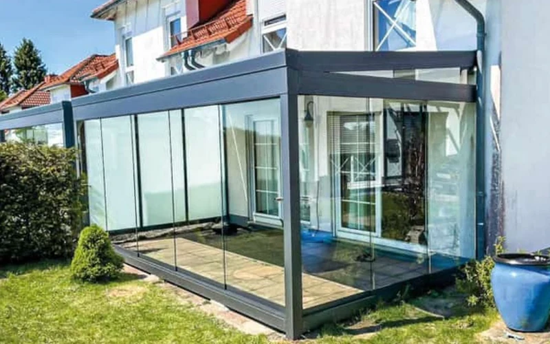 Customer review photo showing a glass garden room with sliding glass doors