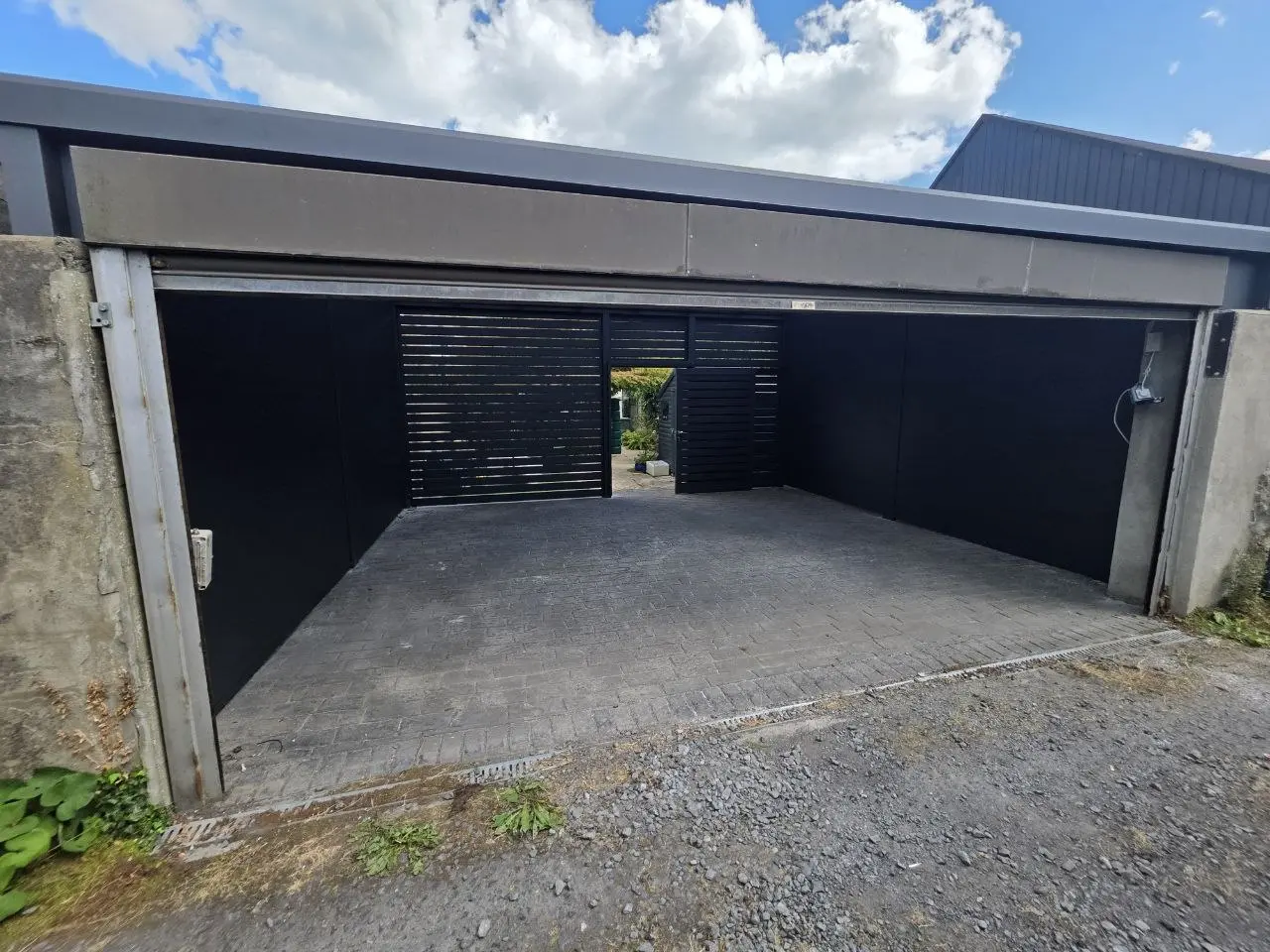 Existing garage entrance incorporated into the enclosed aluminium carport project in Monkstown