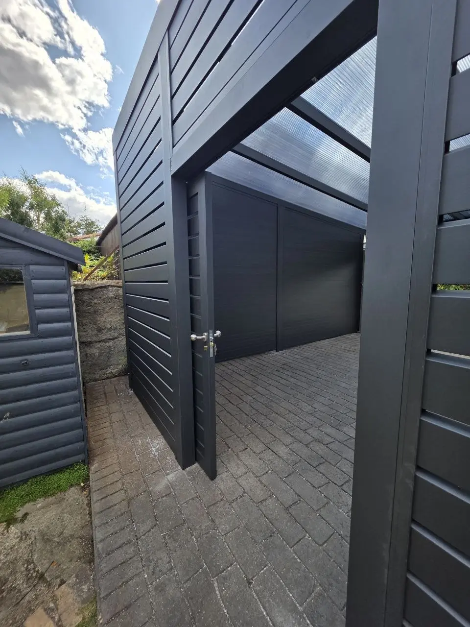 Side view showing the pedestrian access to the enclosed carport garage in Monkstown