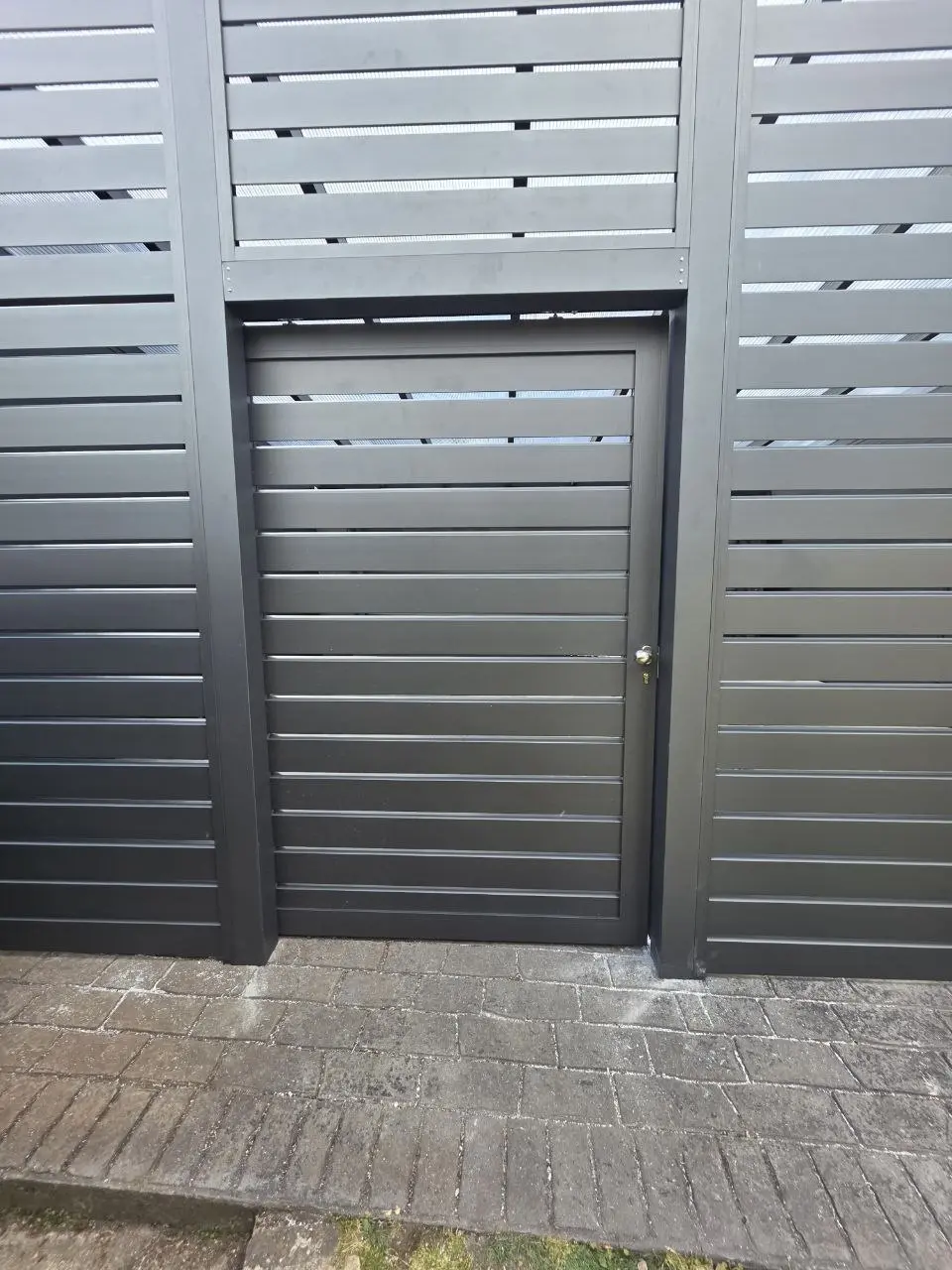 Separate aluminium pedestrian door on the enclosed Monkstown carport garage