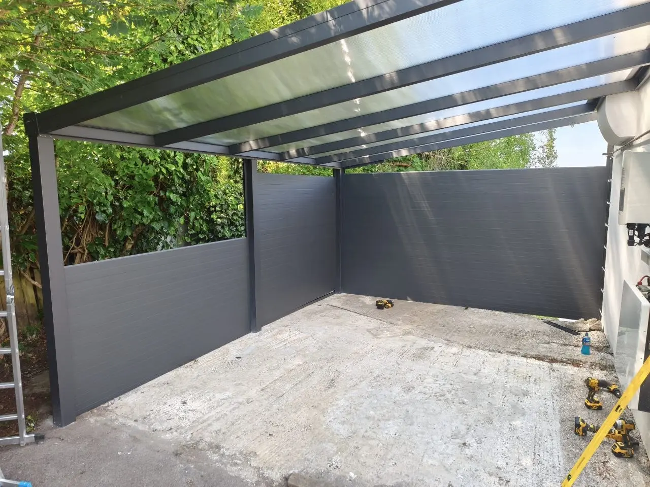 Tongue-and-groove aluminium wall panels during installation of the Kilbride carport
