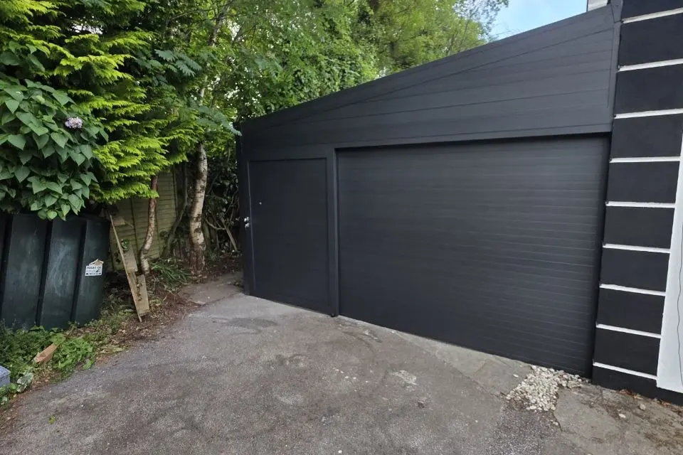 Enclosed aluminium carport combined with residential storage space in Kilbride