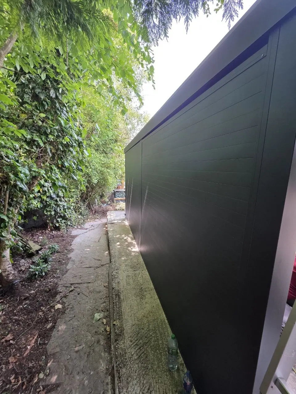 Rear aluminium wall of the enclosed carport beside the property boundary in Kilbride