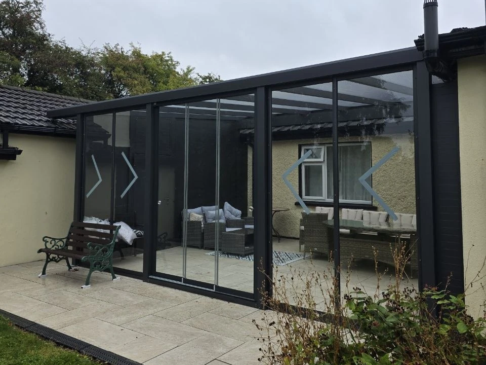 Glass garden room with sliding glass doors at a private home in Ireland