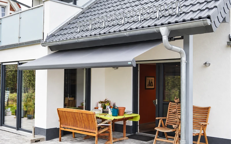 Grey retractable patio awning fitted to a residential terrace