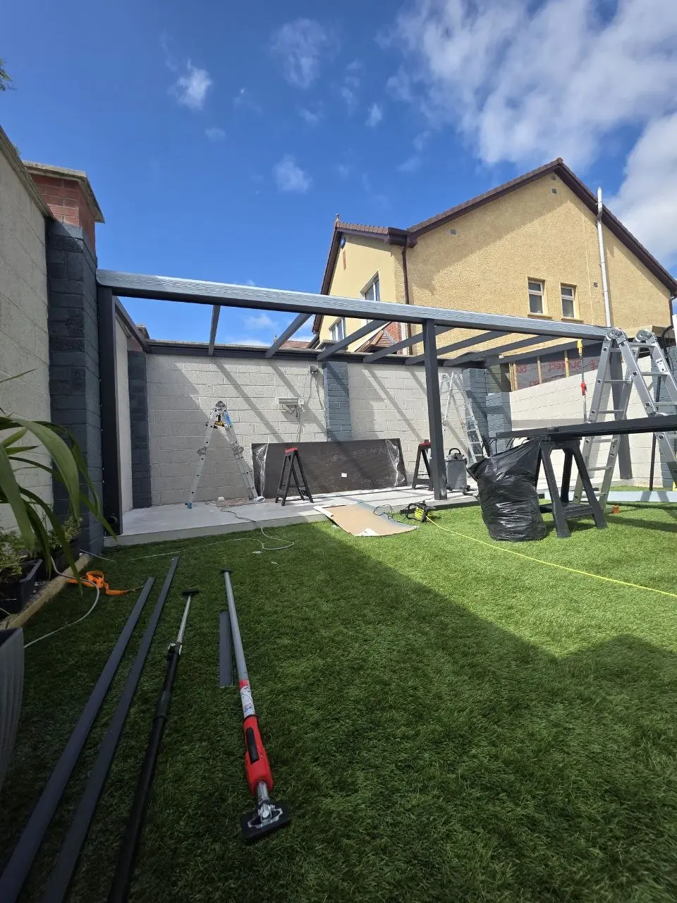 Wide view of the black aluminium patio canopy frame during installation in Limerick