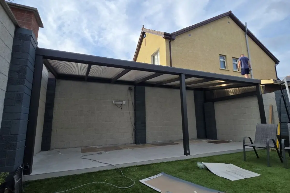 Black wall-mounted aluminium patio canopy with transparent polycarbonate roof completed in Limerick