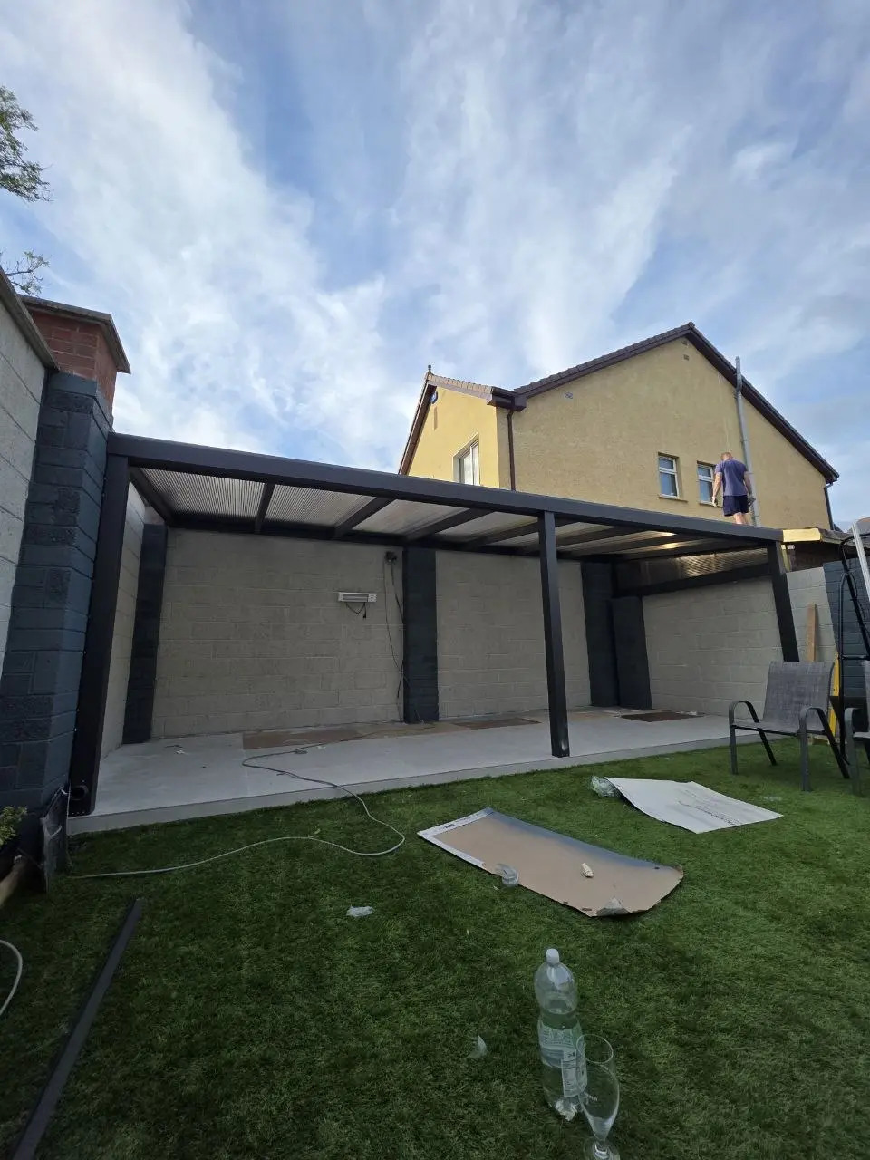 Transparent polycarbonate roof being installed on the residential patio canopy in Limerick