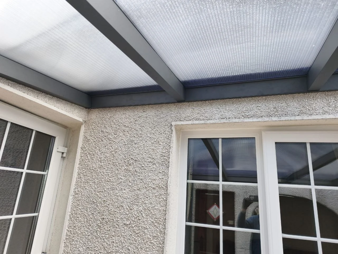 Completed anthracite aluminium courtyard canopy with a polycarbonate roof at a residential property in Dublin