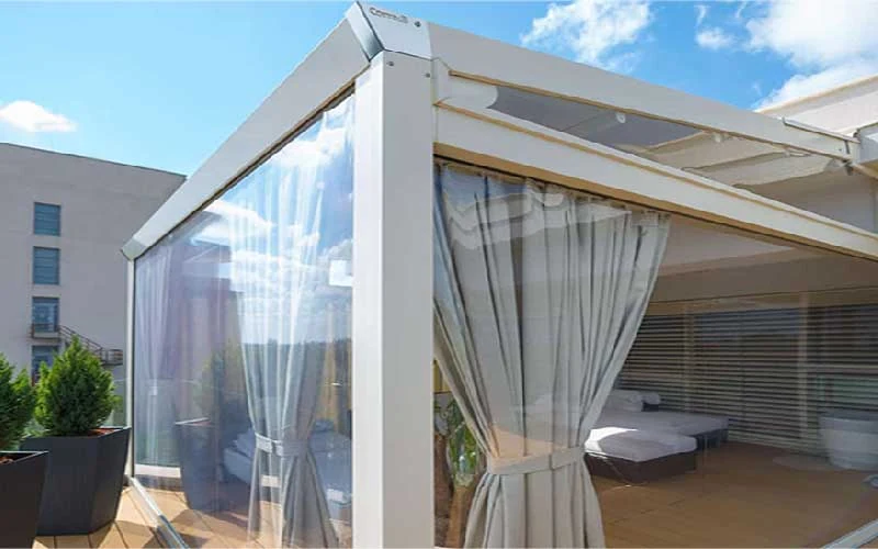 White retractable pergola with fabric roof and curtains