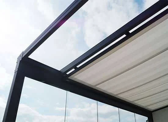 Trend 250 under-roof awning installed below a glass patio roof