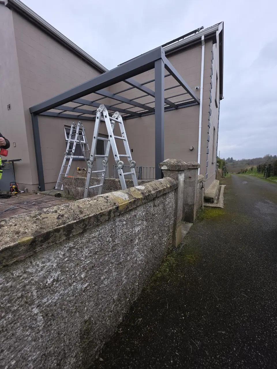 Black aluminium canopy frame installed against the house wall in Cavan