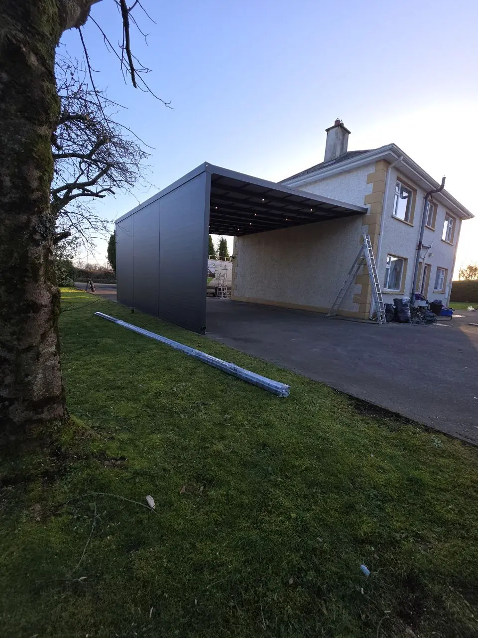 Completed wall-mounted carport with aluminium side panels in Cavan