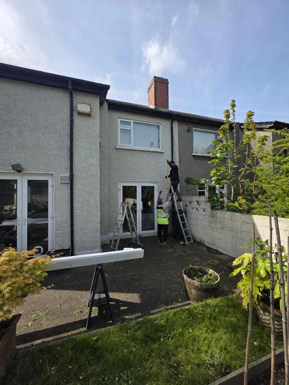 Rear entrance and patio before installation of the white glass pergola in Dublin
