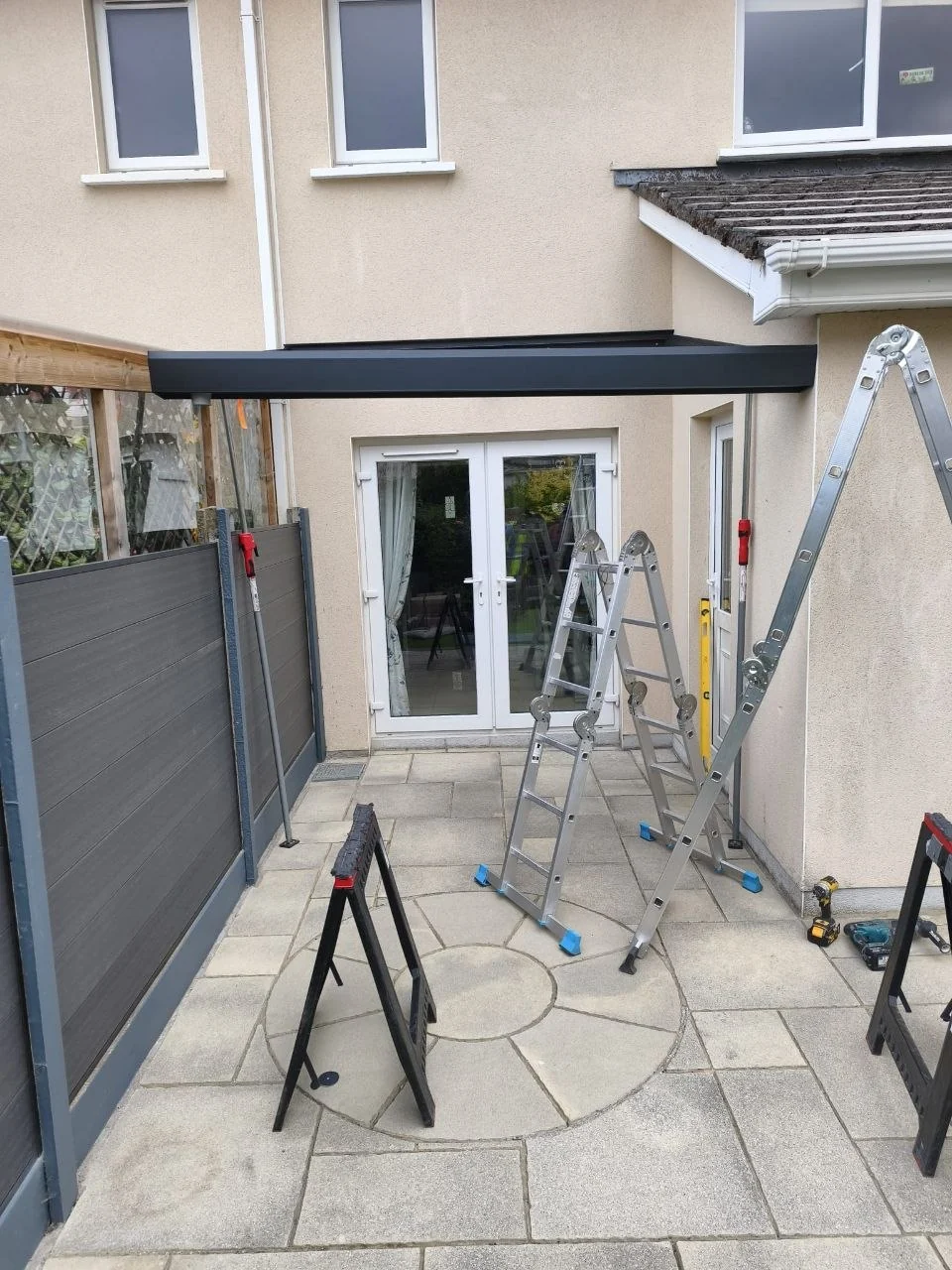 Black aluminium entrance canopy frame during installation at the Dublin home