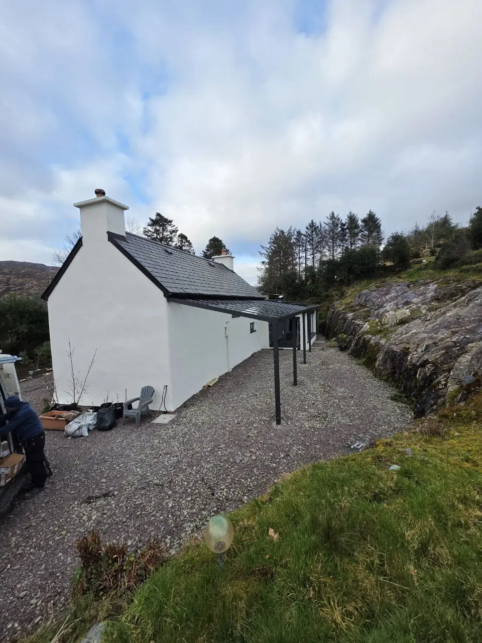 Long side view of the black aluminium and glass pergola in Bantry