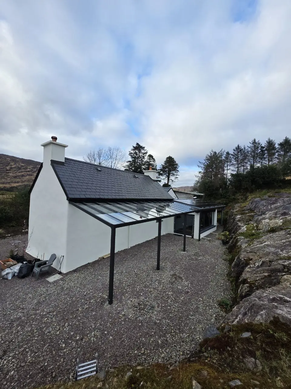 Wide view of the completed glass-roof pergola beside a Bantry home