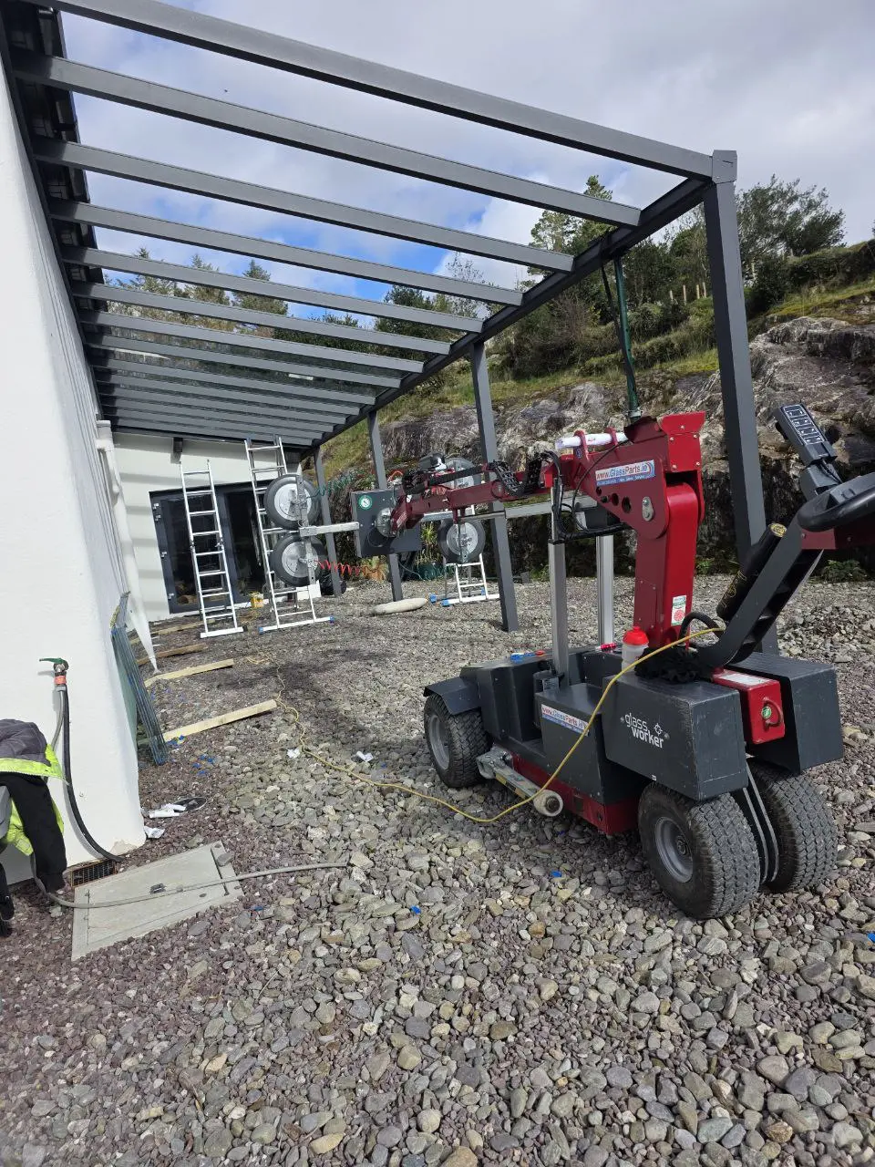 Glass lifting machine used during pergola roof installation in Bantry