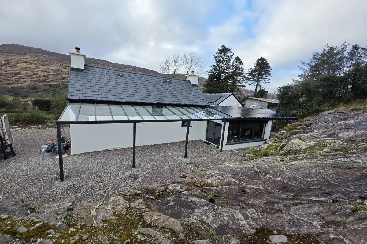 Large black wall-mounted glass pergola at a residential home in Bantry, County Cork