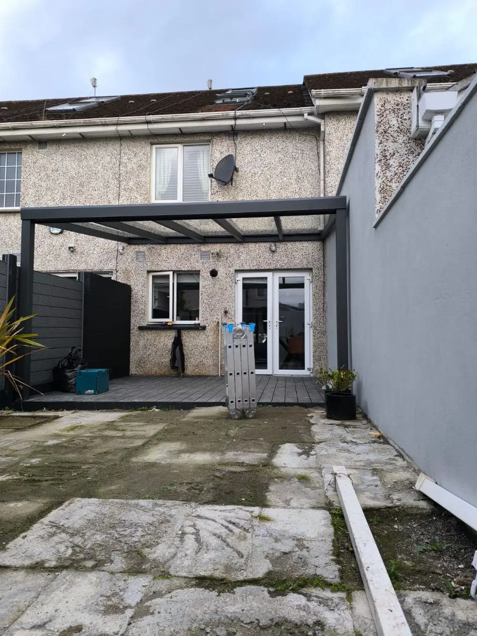 Front view of the black aluminium pergola attached to a Dublin home