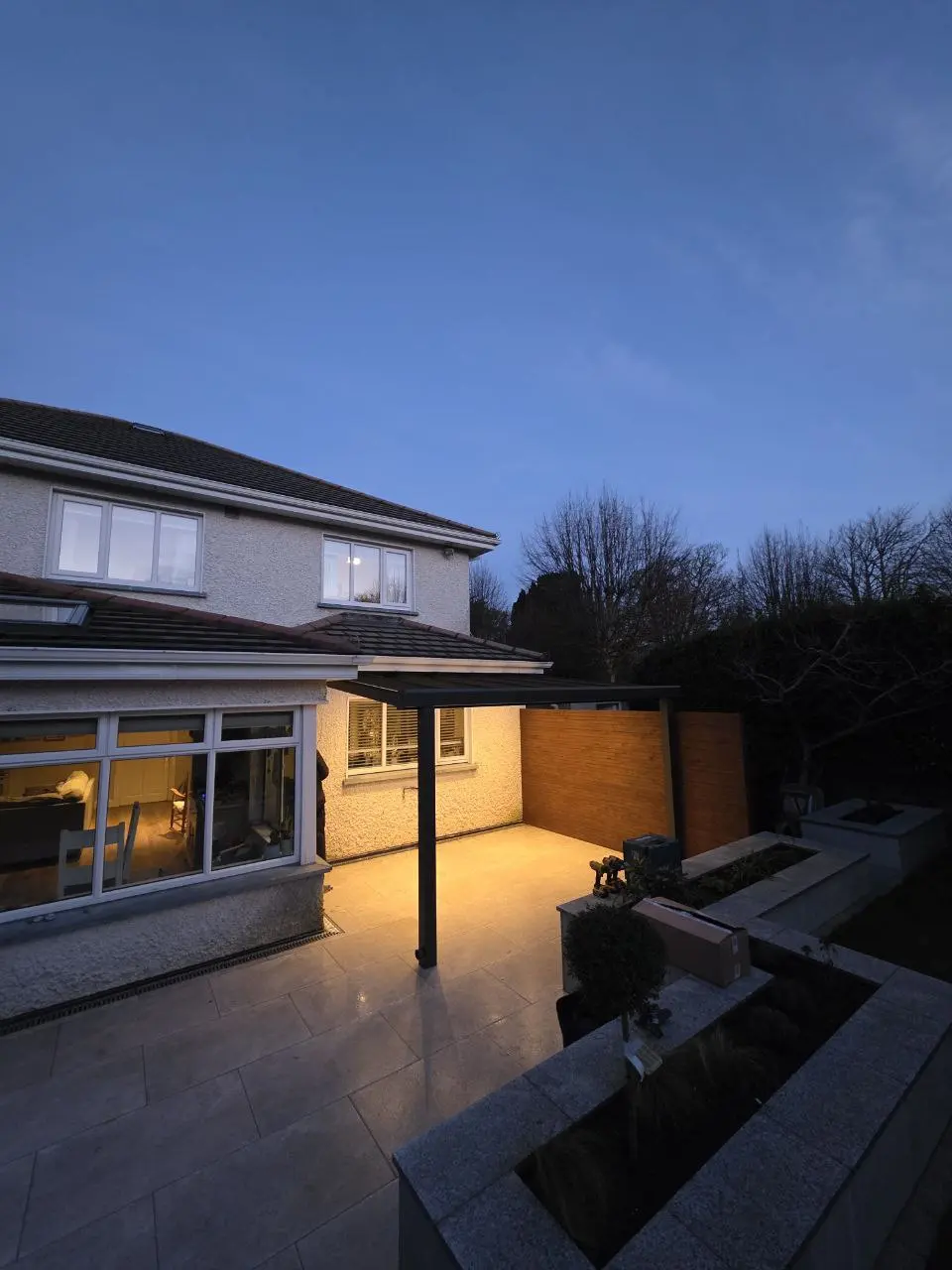 Evening view of the illuminated sheltered patio at a home in Greystones