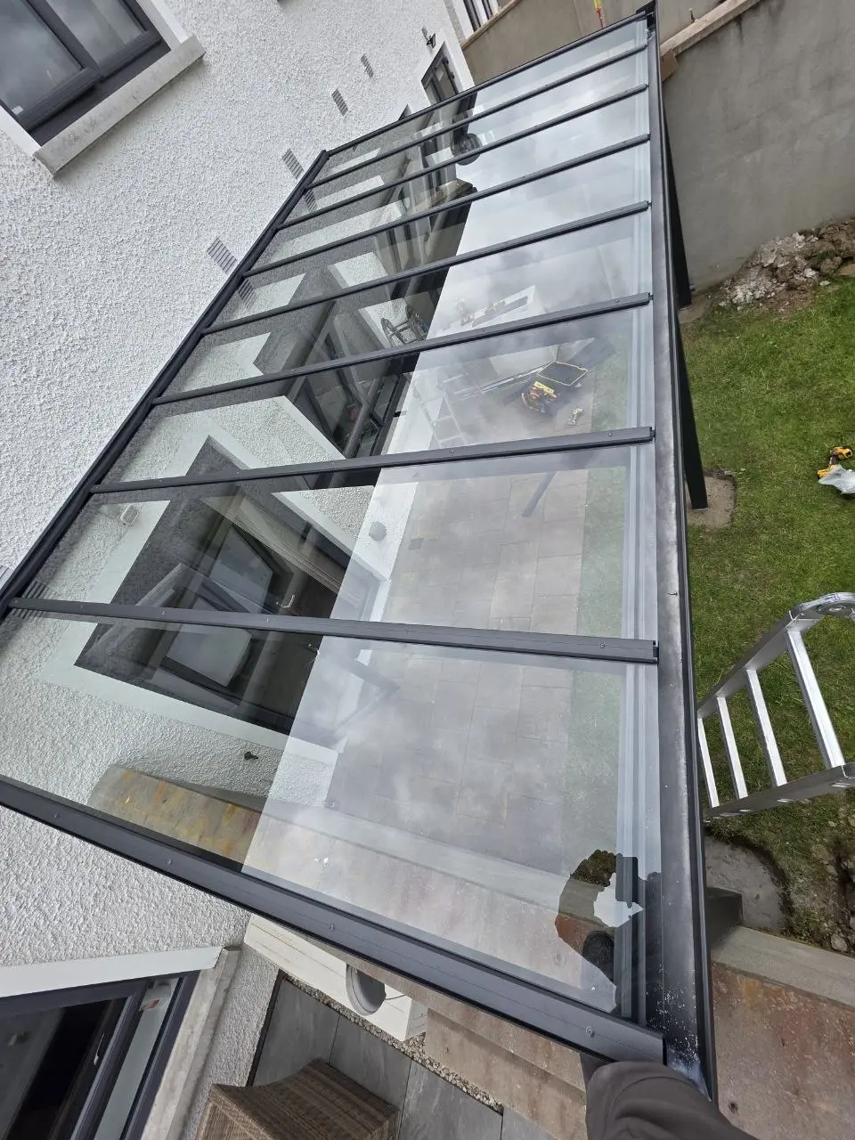 Transparent safety glass roof panels and black aluminium glazing bars