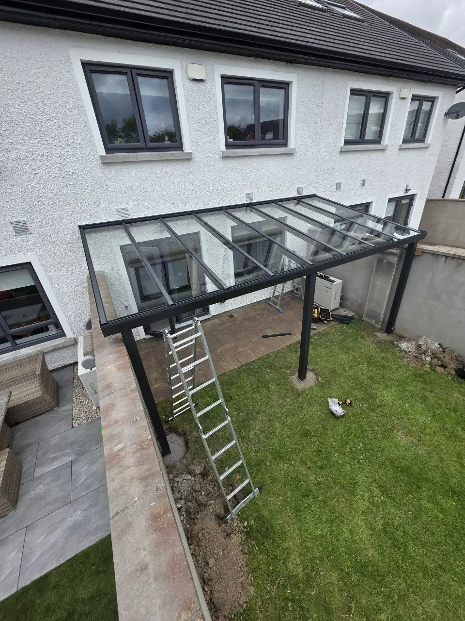 Elevated view of safety glass panels being installed on the pergola in Leixlip
