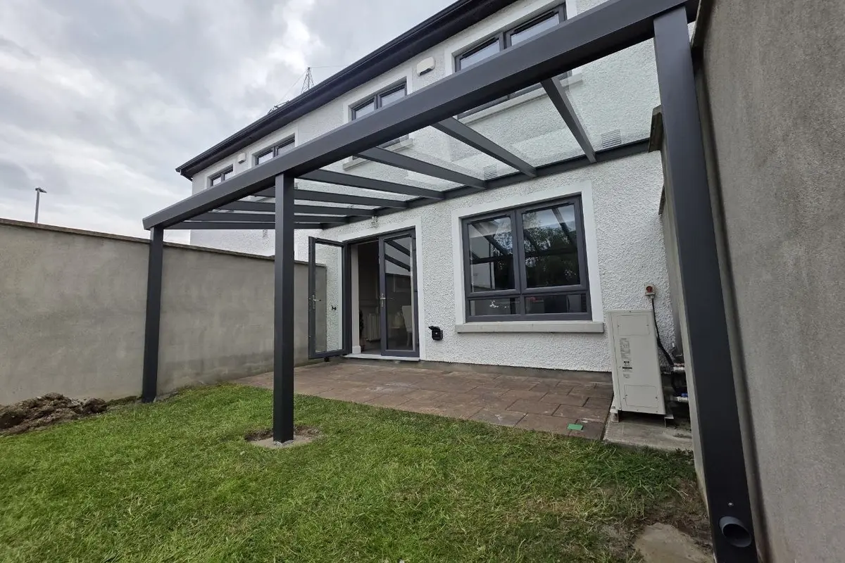 Black wall-mounted glass pergola completed at a residential property in Leixlip, County Kildare