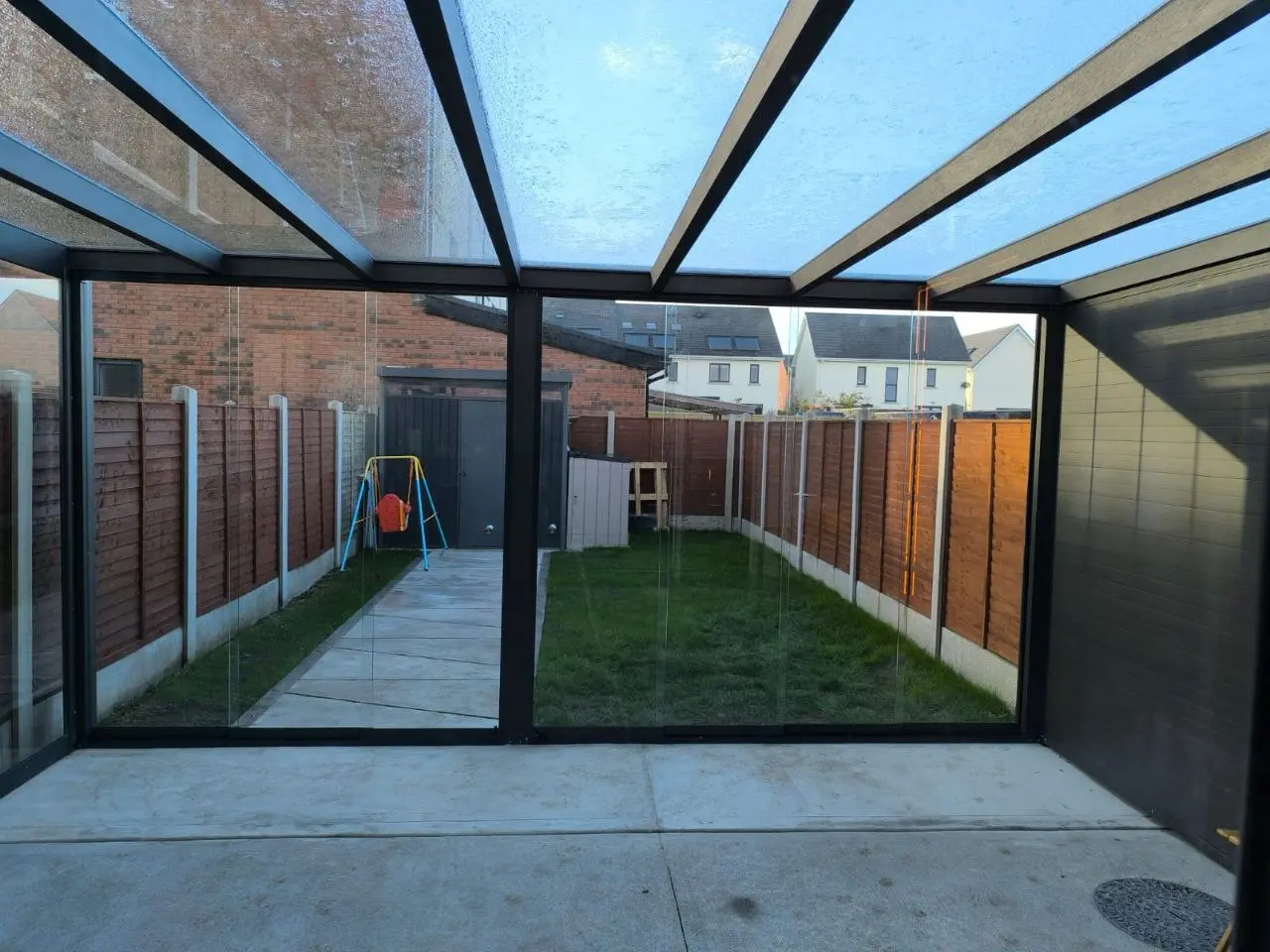 Interior view through the frameless sliding glass systems of the Dublin pergola